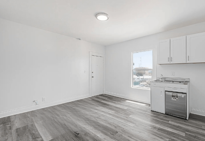 A kitchen area with a dishwasher and a window.
